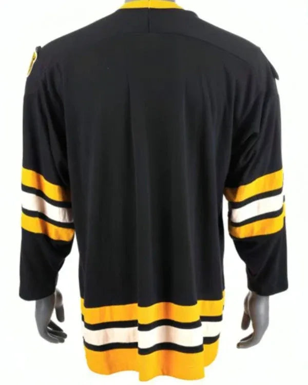 Black hockey jersey with yellow and white stripes on a mannequin against a white background