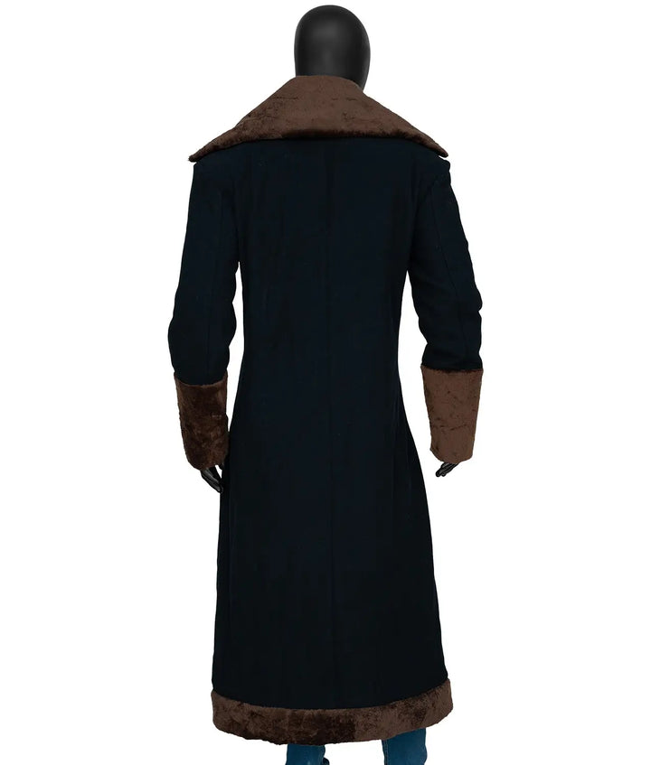 Black coat with brown fur trim on a mannequin against a white background