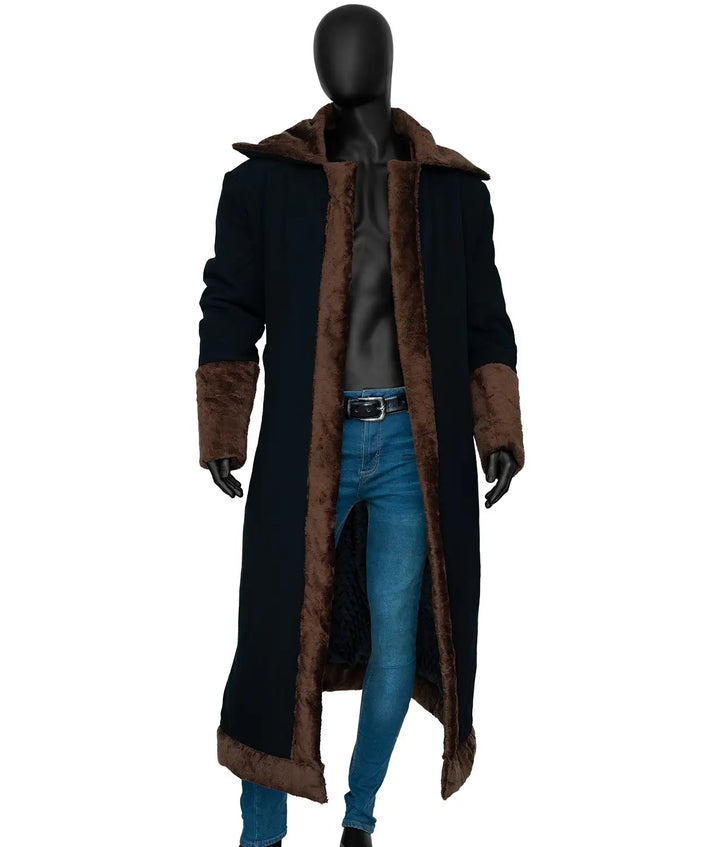 Mannequin wearing a long black coat with brown fur trim on a white background