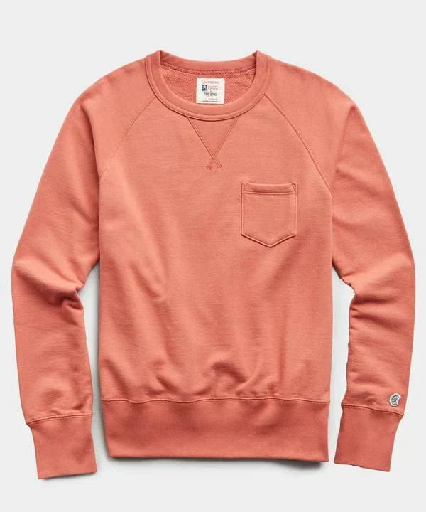 Coral sweatshirt with a pocket on a light gray background