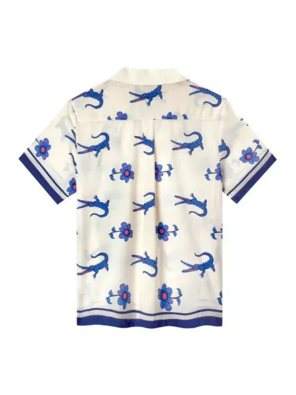 White shirt with blue lizard and flower pattern on a white background