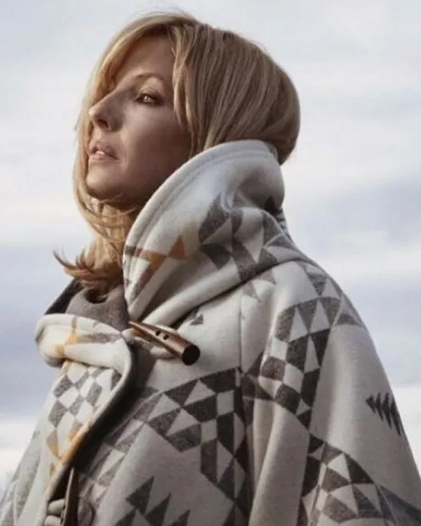 Person wearing a Yellowstone Beth Dutton White Poncho Coat over their shoulders against a cloudy sky.
