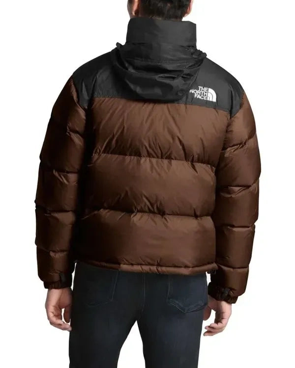 Brown puffer jacket with black hood and The North Face logo on a white background